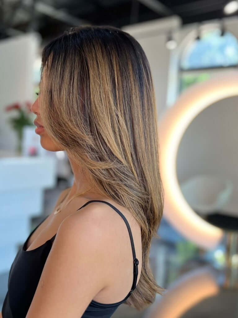 Woman with styled hair in a salon setting